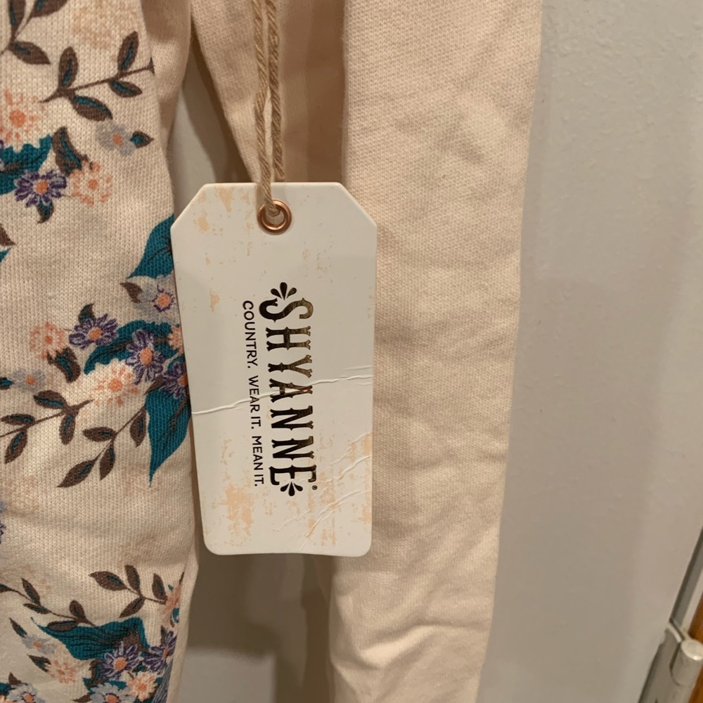 Nice brand new Hoodie with flowers on the front solid back color